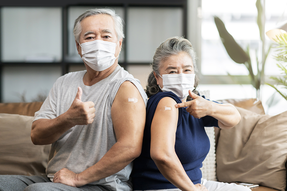 old asian senior couple wearing face mask virus protection happi